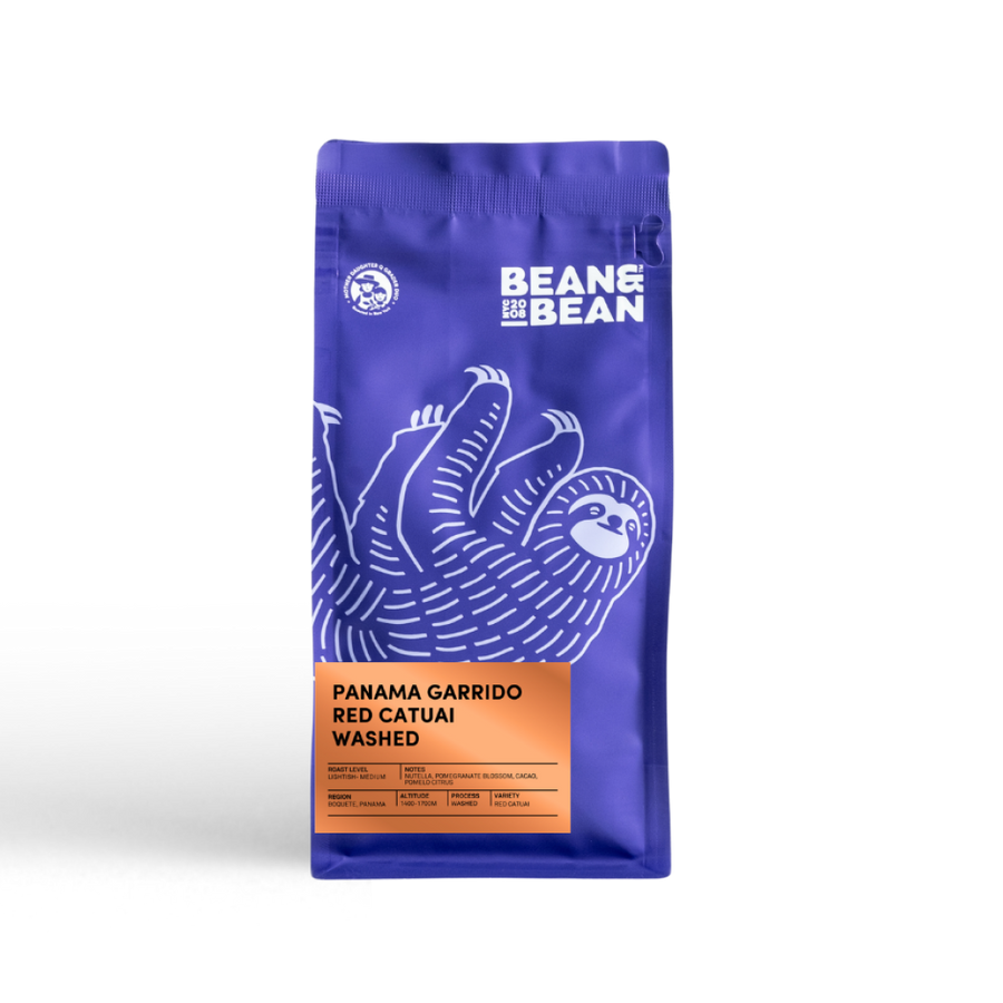 Purple coffee bag with a sloth, orange label—Panama Gissell Garrido by Bean & Bean Coffee Roasters. - media