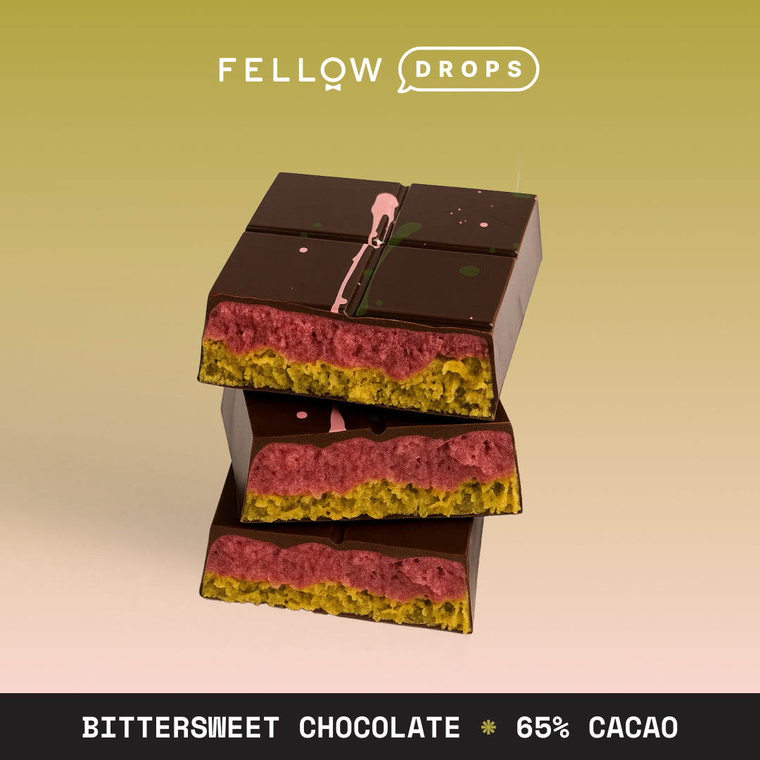 Three stacked Charles Chocolates Raspberry Dubai Done Better Bars with pistachio cream.