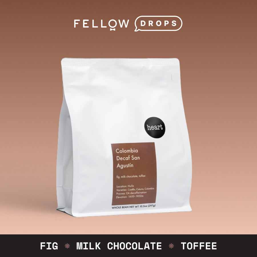 A white bag of Heart Coffee Roasters Colombia Decaf San Agustín on a brown background. - media