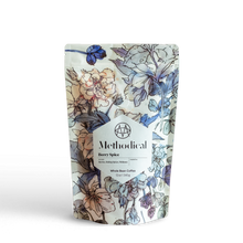 Methodical Coffee’s Berry Spice, a medium-light roast, in a floral-patterned bag on white background.