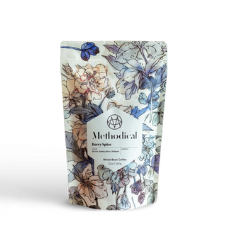 Methodical Coffee’s Berry Spice, a medium-light roast, in a floral-patterned bag on white background.