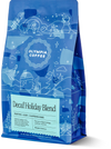 Olympia Decaf Holiday Blend coffee bag with white winter illustrations and a light blue label.