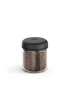 Fellow Atmos Vacuum Canister with black lid, storing coffee beans on a white background.