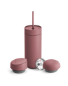 Fellow Carter 3-in-1 Lid System matte pink mug with straw and two containers on white background.