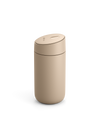 Fellow Carter Slide Mug, beige, with rounded lid on a white background.