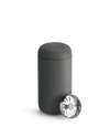 Matte black Fellow Carter Move Mug with round metal lid, partially open on a white background.