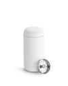A Fellow Carter Move Mug with a metal lid sits beside it on a plain background.