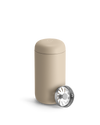 Beige Fellow Carter Move Mug with removable metal infuser lid placed beside it.