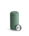 Matte green Fellow Carter Move Mug with lid and metal strainer in front.