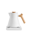 Fellow Corvo EKG Electric Kettle with wooden handle on a sleek white base.