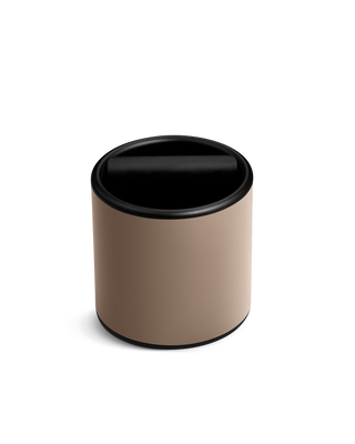 The Fellow Espresso Knock Box in Malted Chocolate has a swing lid and silicone-wrapped knock bar.