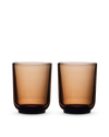 Two Fellow Pirch Espresso Glasses in amber sit on a white background.