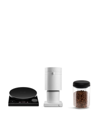 Fellow’s The Weigh To Go Kit: black scale, white grinder, and glass bean jar on a white background.