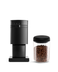 The Grind It Kit by Fellow: black grinder, coffee kit, and airtight jar of fresh beans.