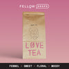 A Fellow Love herbal tea bag on pink, brown pack, with Masha tasting notes below.