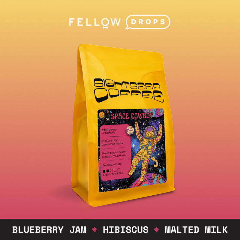 A yellow bag of Sightseer Coffee's Space Cowboy with colorful astronaut art.