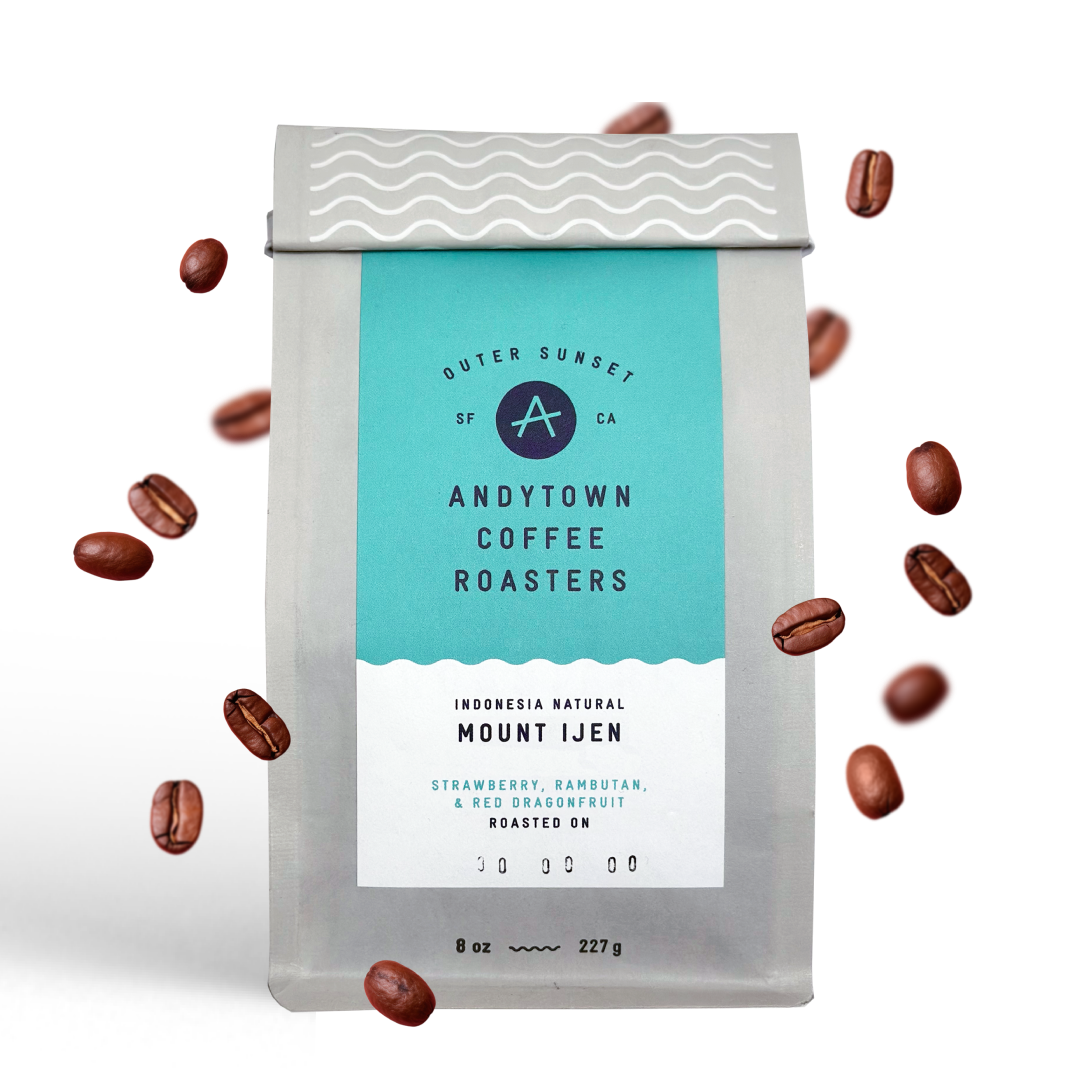 A bag of Andytown Coffee Roasters Indonesia Natural Mount Ijen with coffee beans floating around.