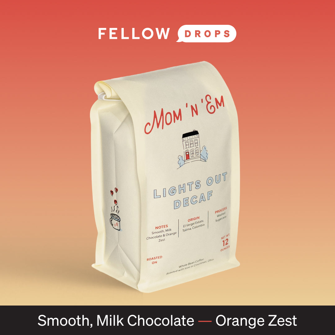 A bag of Mom 'n 'em Coffee Lights Out Decaf on a red-orange gradient background.