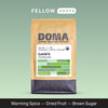 A brown bag labeled Lucia’s Guatemala from DOMA Coffee Roasting Company with flavor notes.