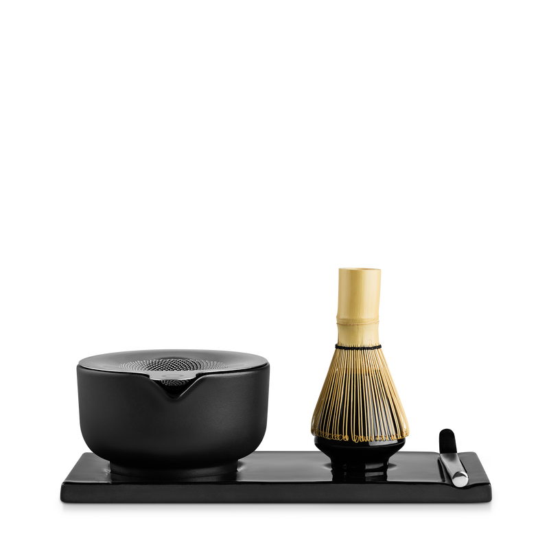 Fellow Matcha Set in matte black: ceramic bowl, bamboo whisk, spoon & tray on white background.