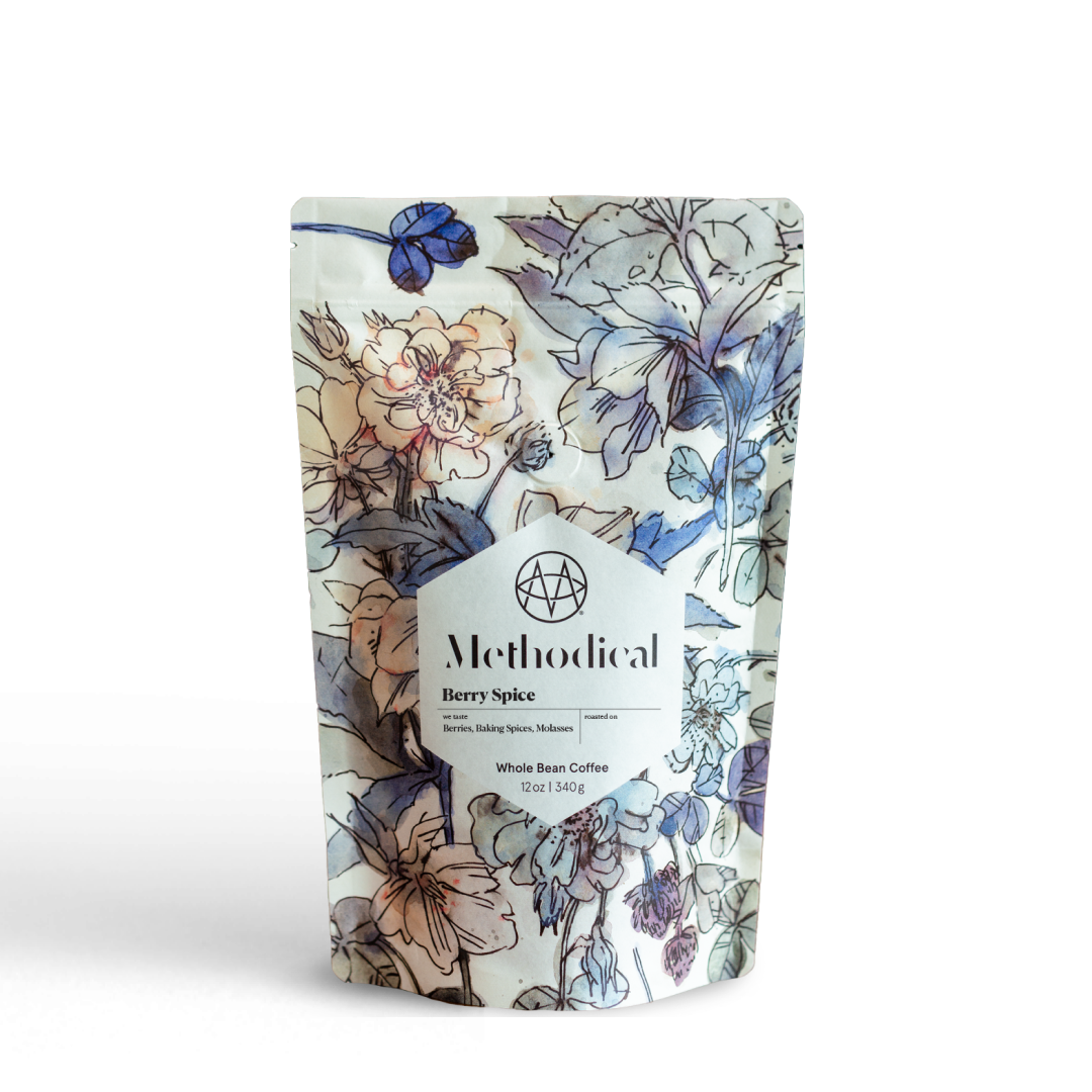 Methodical Coffee’s Berry Spice, a medium-light roast, in a floral-patterned bag on white background.