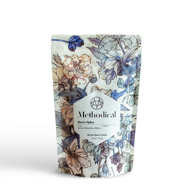 Methodical Coffee’s Berry Spice, a medium-light roast, in a floral-patterned bag on white background.