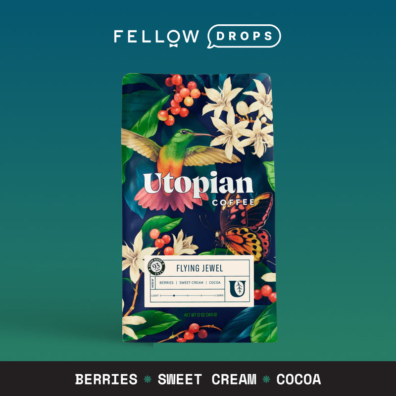 A colorful bag with a hummingbird, flowers, and text: Flying Jewel by Utopian Coffee.