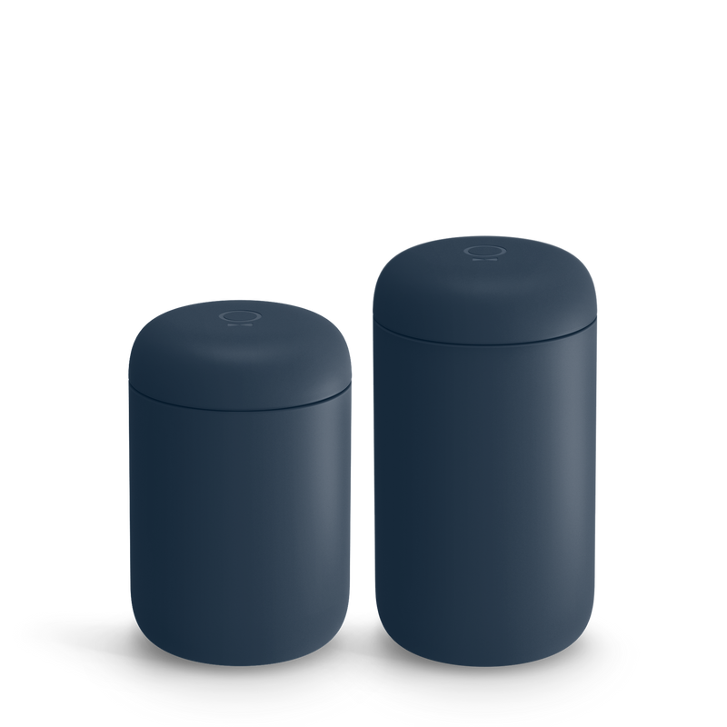 Two matte dark blue containers with rounded lids, perfect for a stylish home barista design.