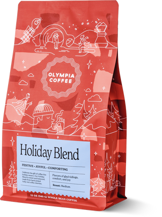 Red Olympia Holiday Blend coffee bag with white winter illustrations and label details.
