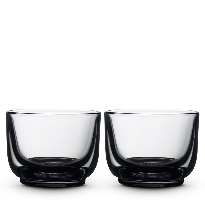 Two smoke Pirch Espresso Glasses by Fellow sit side by side on a plain white background.