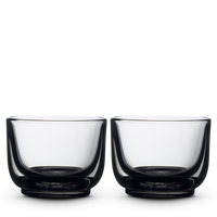 Two smoke Pirch Espresso Glasses by Fellow sit side by side on a plain white background. - media thumbnail