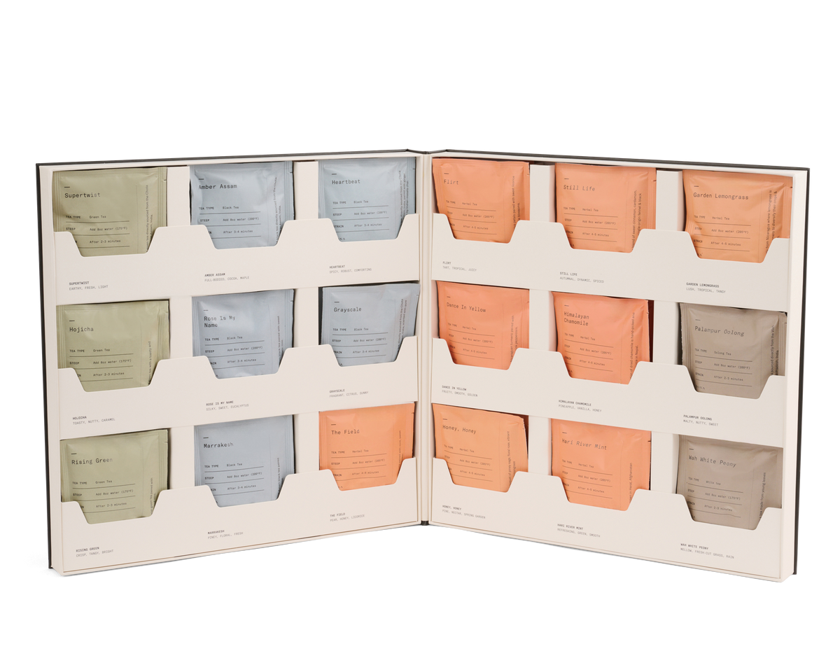 Open Dona Tea Library box displaying an organized collection of twelve assorted tea sachets.