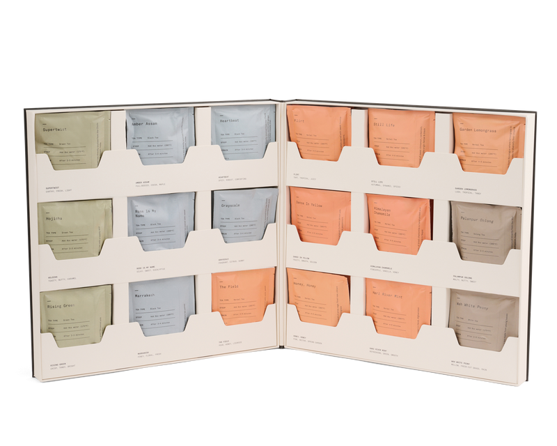 Open Dona Tea Library box displaying an organized collection of twelve assorted tea sachets.