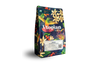 A vibrant Obsidian bag by Utopian Coffee with Latin American beans, florals, birds, and butterflies.