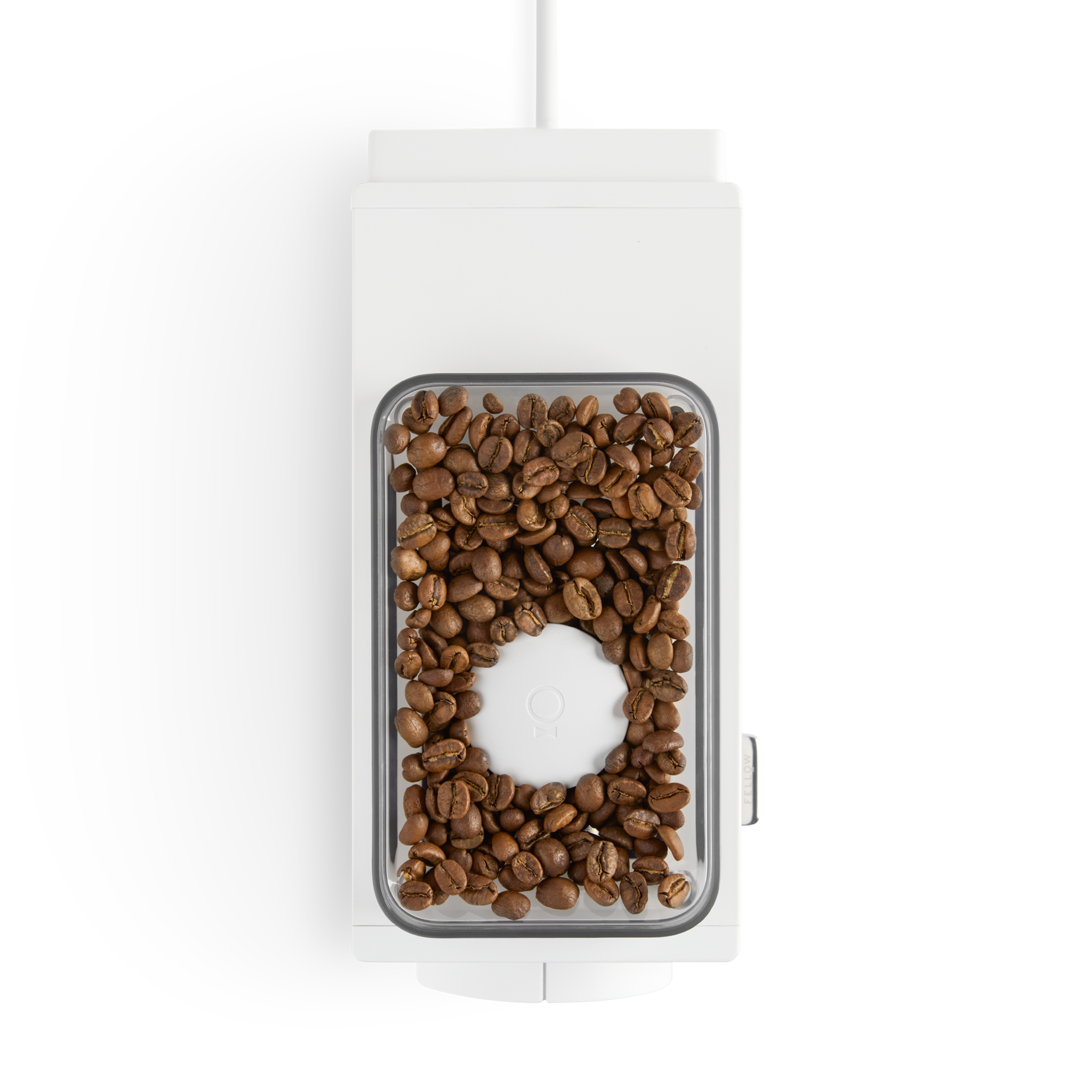 Top view of a white coffee grinder with whole coffee beans—perfect for any home barista.