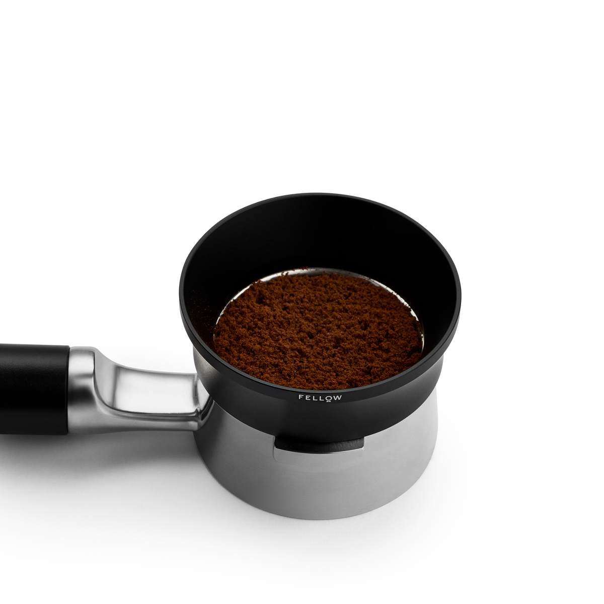 Fellow Espresso 58 mm Magnetic Dosing Funnel fits 58 mm portafilters; shown with coffee grounds.