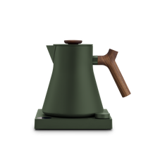 Fellow Corvo EKG Woodland + Walnut electric kettle with wooden handle on matching base. - media thumbnail