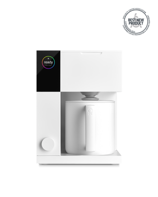 Fellow Aiden Precision Coffee Maker in matte white brews coffee easily into a matching mug.