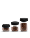 Fellow Atmos Vacuum Canister 3 Pack stores coffee beans in clear jars with black lids.