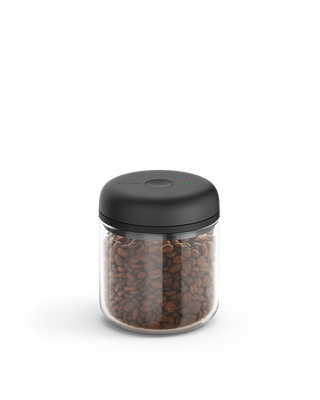 Fellow Atmos Vacuum Canister with black lid, storing coffee beans on a white background.