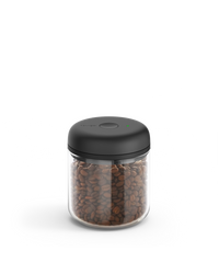 Fellow Atmos Vacuum Canister with black lid, storing coffee beans on a white background. - media thumbnail