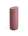 The Fellow Carter Slide Mug is a matte pink reusable travel mug with a rounded lid.