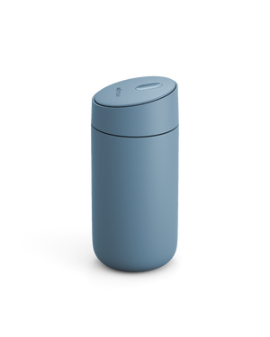 Fellow Carter Slide Mug in matte blue with rounded shape and matching lid, on white background.
