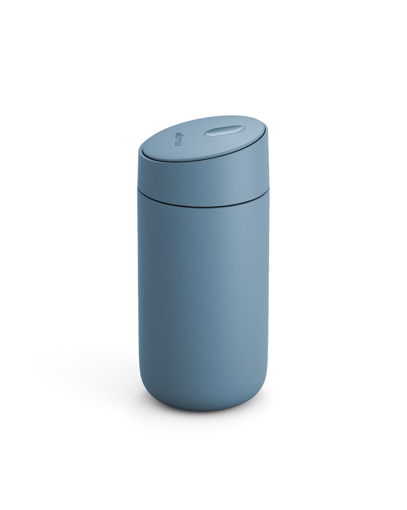 Fellow Carter Slide Mug in matte blue with rounded shape and matching lid, on white background.