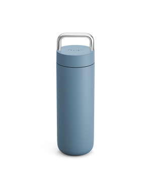 Fellow Carter Carry Travel Mug in Hazy Blue with a metal handle on a white background.