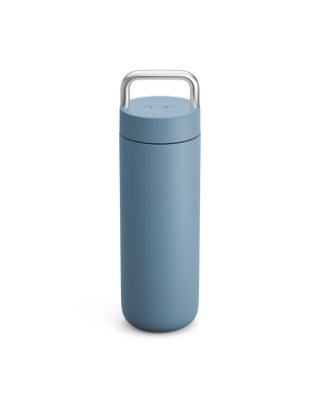 Fellow Carter Carry Travel Mug in Hazy Blue with a metal handle on a white background.