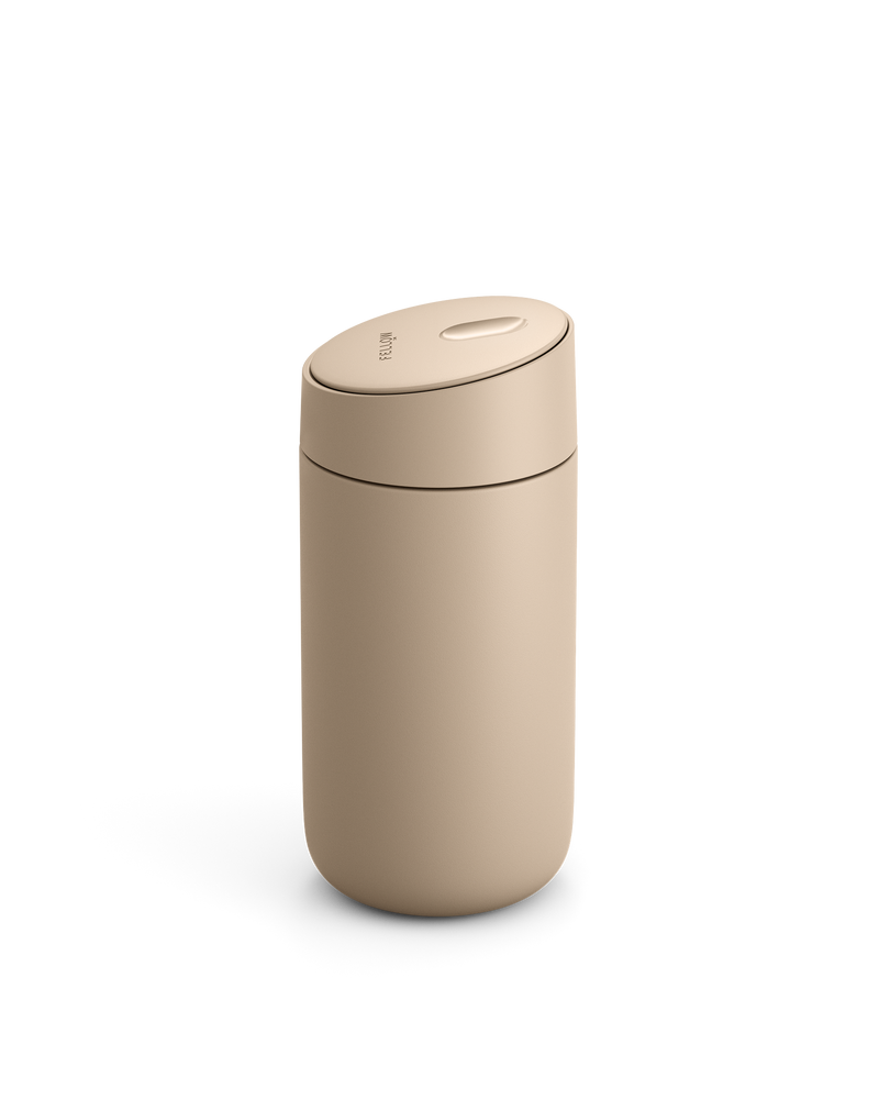 Fellow Carter Slide Mug, beige, with rounded lid on a white background.