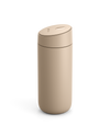 Fellow Carter Slide Mug in beige with oval push-button lid on a white background.