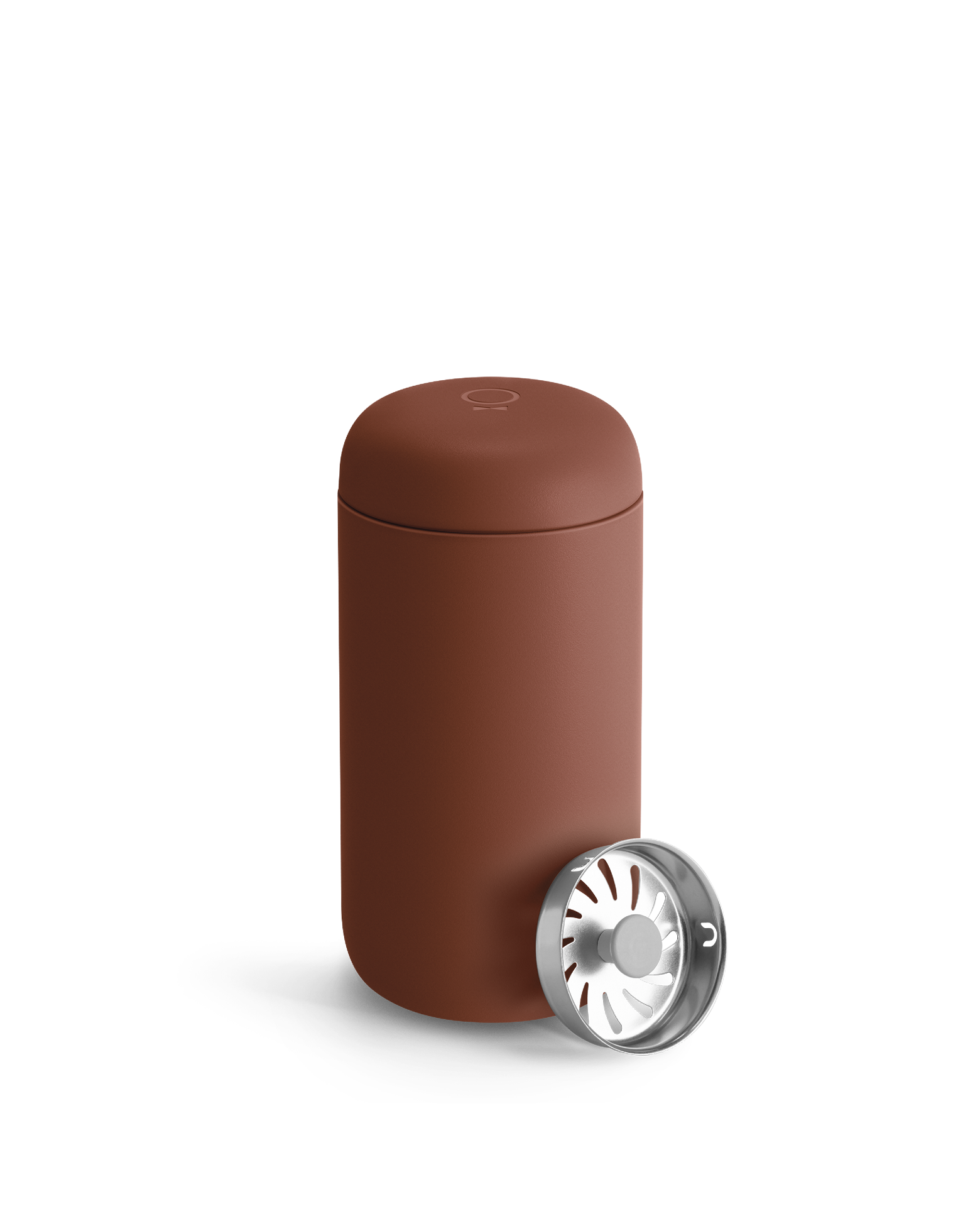 Fellow Carter Move Mug with lid next to a metal part with radial openings.