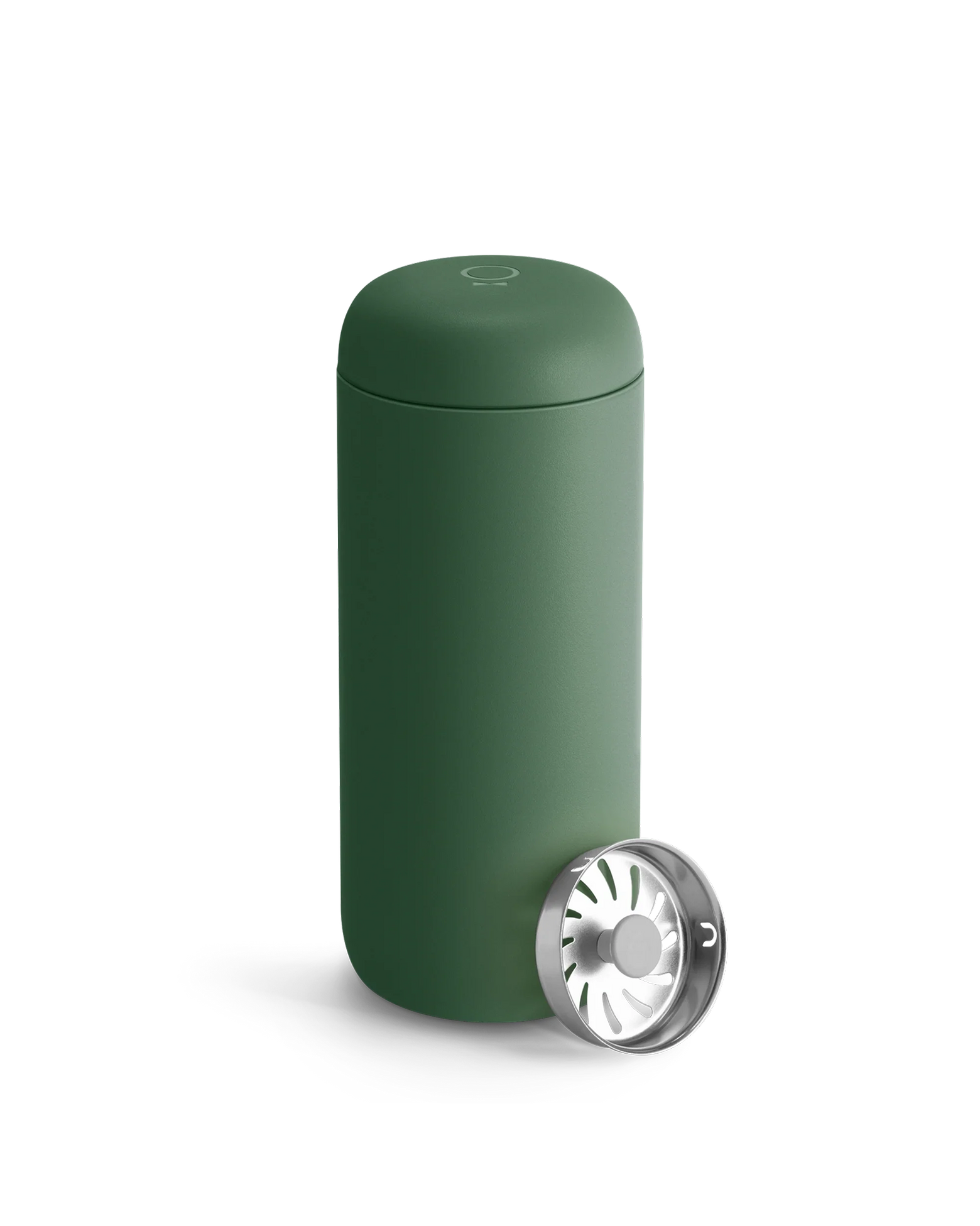 A matte green Fellow Carter Move Mug with a metal strainer leaning against it.